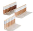 Set of concealer bottles in various shades on a white background
