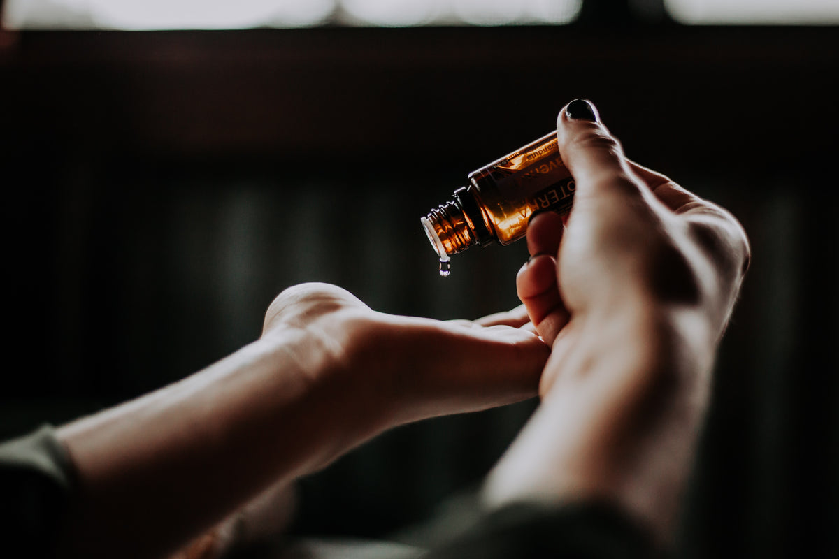 Person putting skincare in their palm